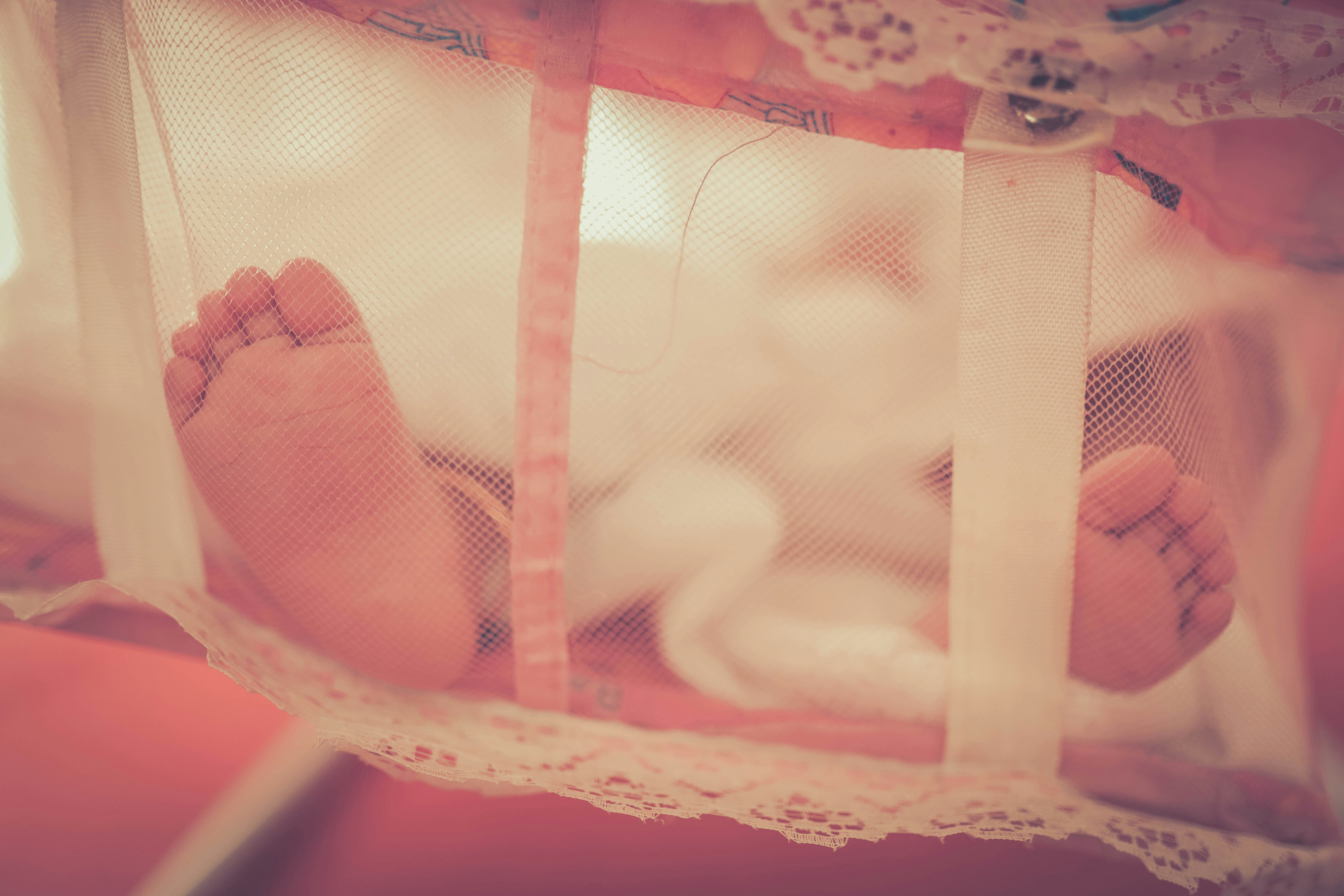 baby laying on crib